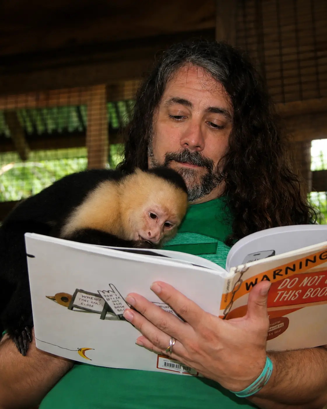 Adam reading with a monkey
